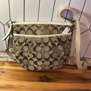 She is cute! Coach white and tan crossbody.